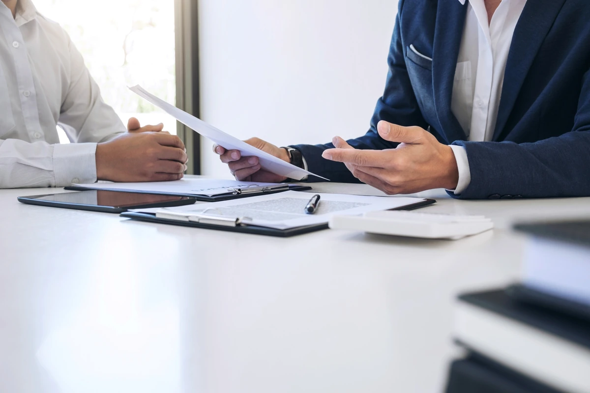 Business professionals reviewing documents at a meeting