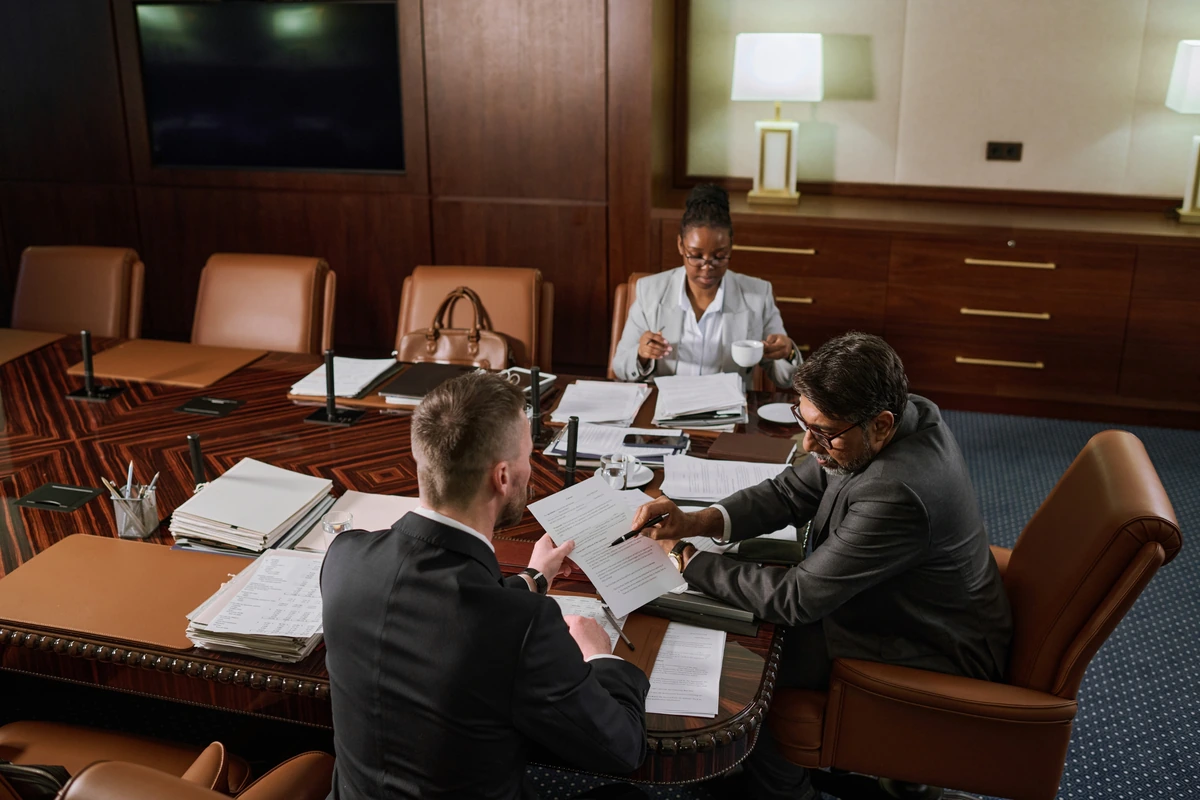 Business professionals reviewing documents in a conference room
