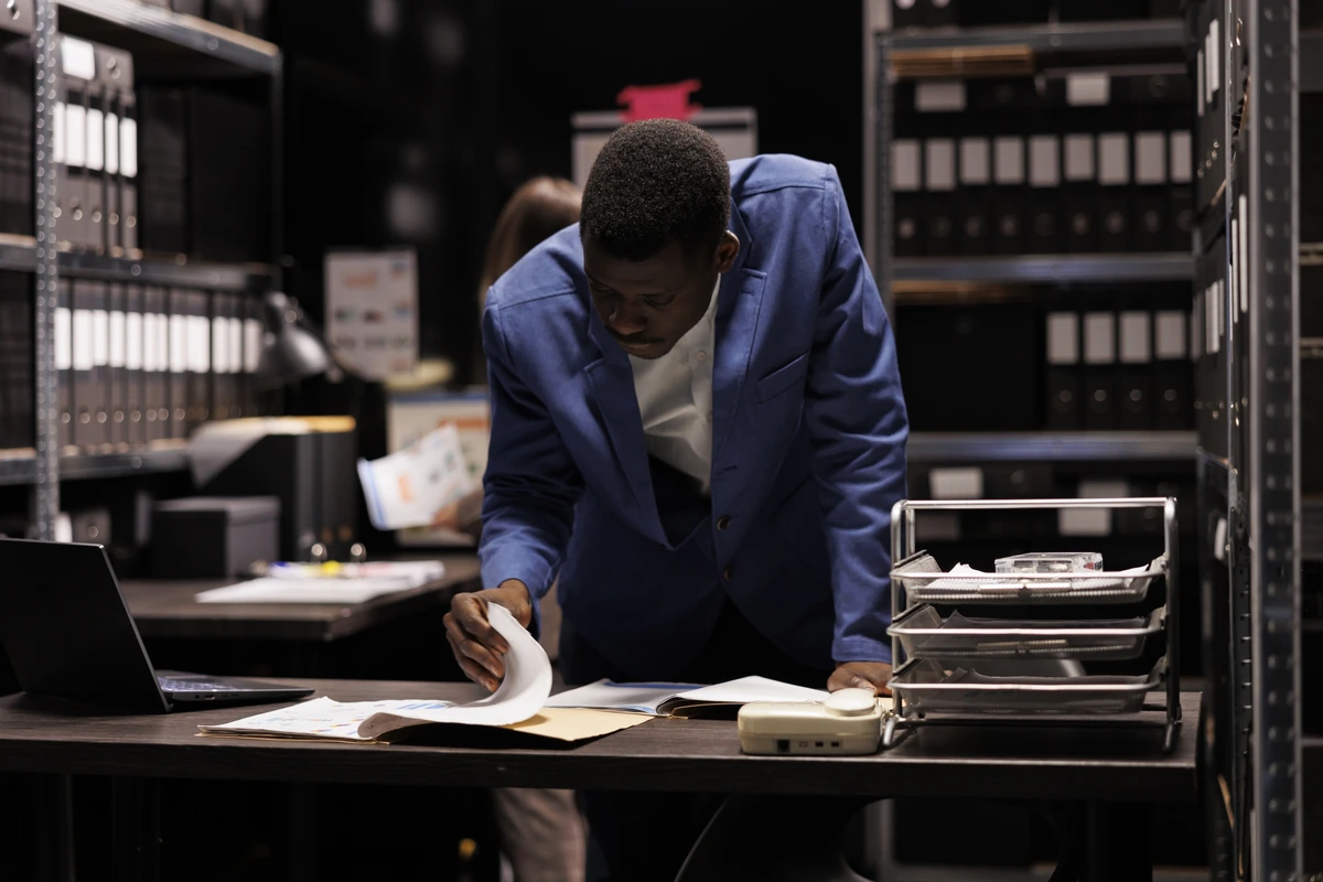 An attorney examining business records in a law library